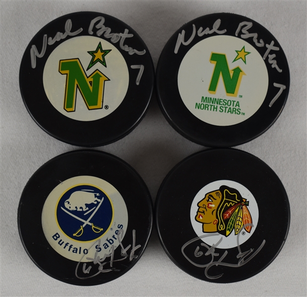 Neal Broten & Phil Housley Lot of 4 Autographed Hockey Pucks